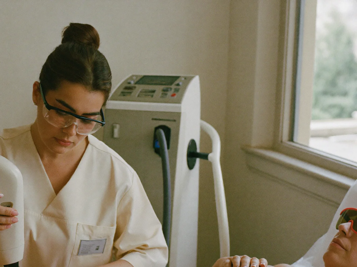 Laser specialist and client wearing protective eyewear during treatment